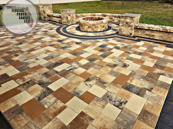 Warm multicolor paver patio with a round fire pit and curved seating wall