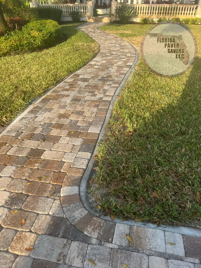 Curving paver walkway through lawn and landscaped planting beds