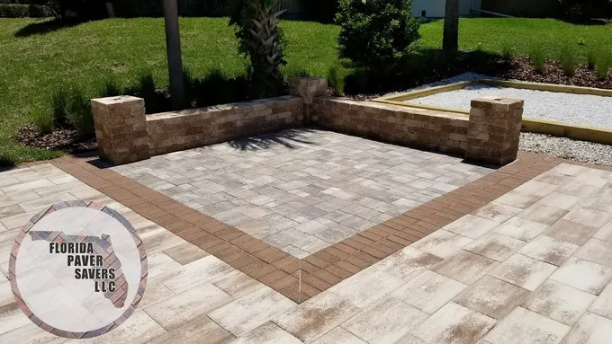 Commercial paver gathering area enclosed by low seating walls and capped pillars
