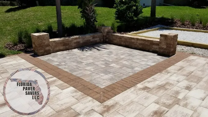 Commercial paver gathering area enclosed by low seating walls and capped pillars